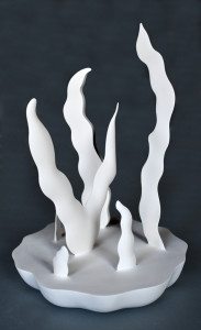 narrow, pointed abstract shapes rising out of a flower-like base in plaster